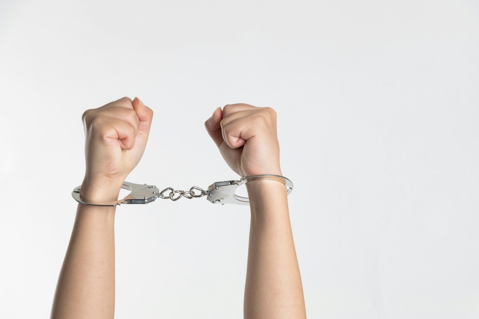 Raised fists in handcuffs